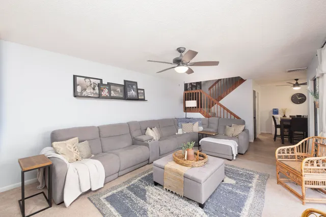 a living room with furniture and wooden floor