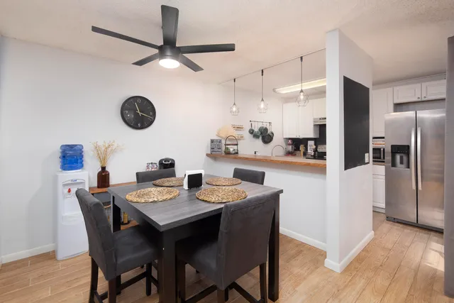 a kitchen with a dining table and chairs