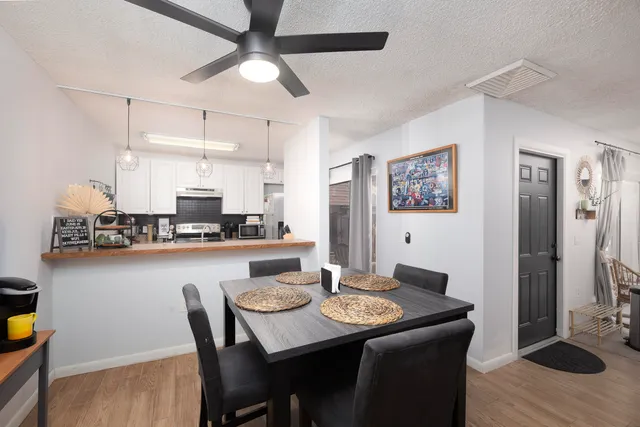 a view of a dining room with furniture and wooden floor