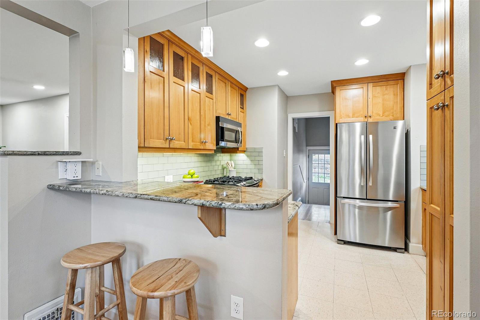 1312 Ash Street Denver, CO 80220 - Photo 13 of 31 a kitchen with stainless steel appliances granite countertop a sink and a refrigerator