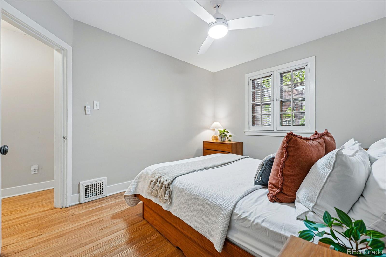 1312 Ash Street Denver, CO 80220 - Photo 18 of 31 a bedroom with a bed and wooden floor