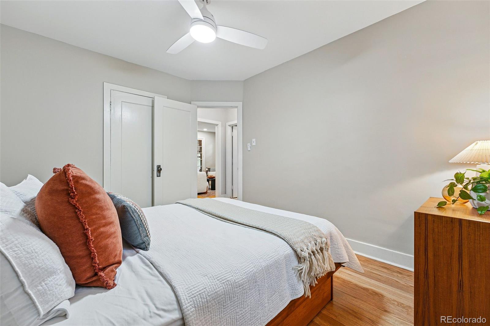 1312 Ash Street Denver, CO 80220 - Photo 19 of 31 a bedroom with a bed and a chandelier