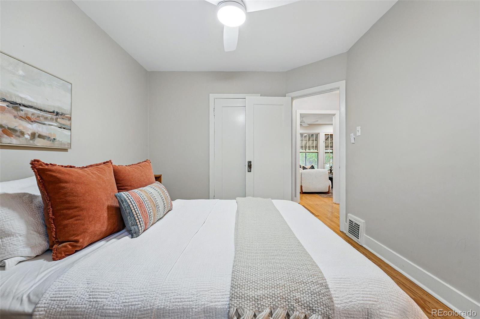 1312 Ash Street Denver, CO 80220 - Photo 20 of 31 a bedroom with a bed and a chandelier