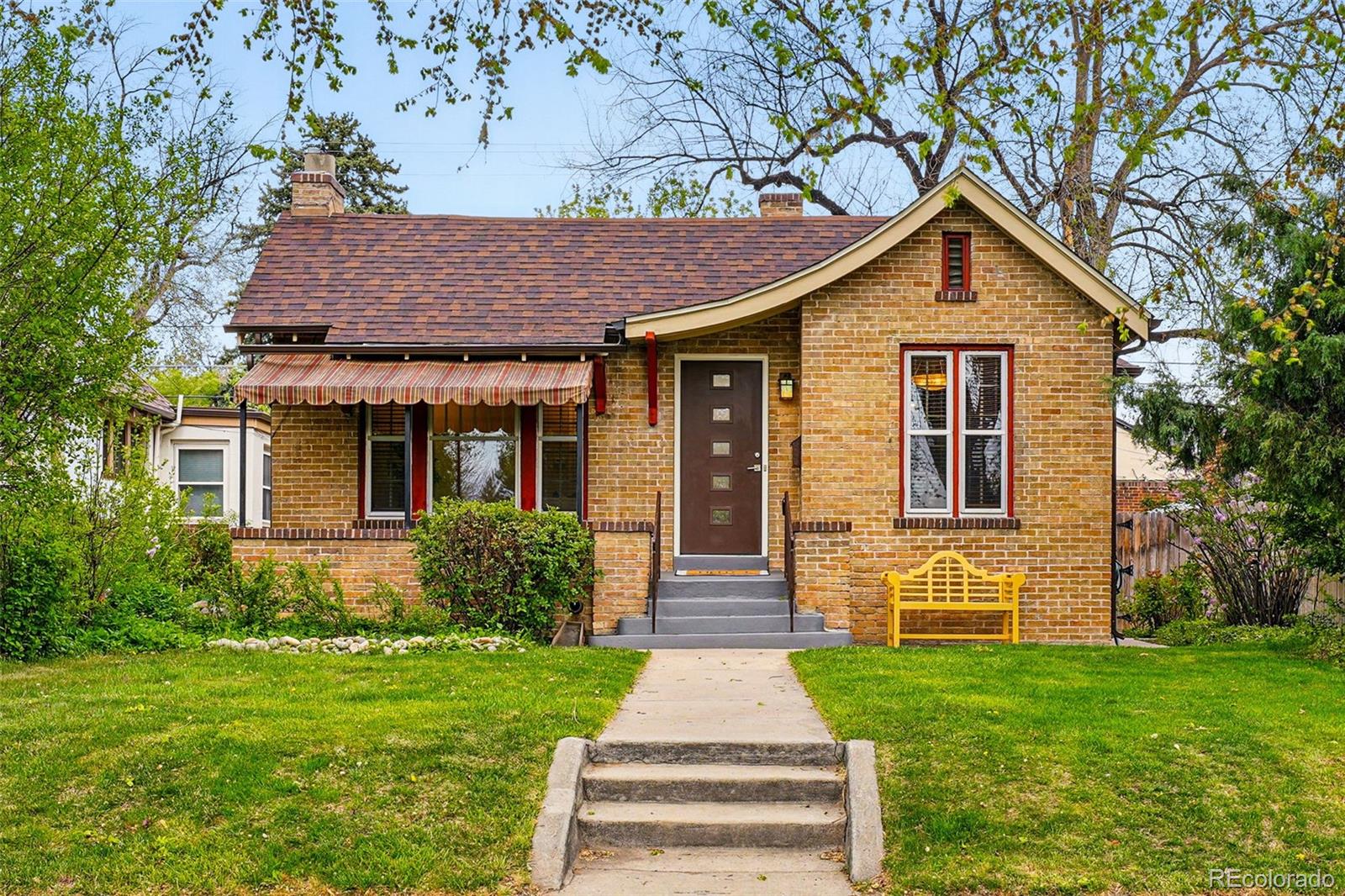 1312 Ash Street Denver, CO 80220 - Photo 2 of 31 a front view of a house with garden