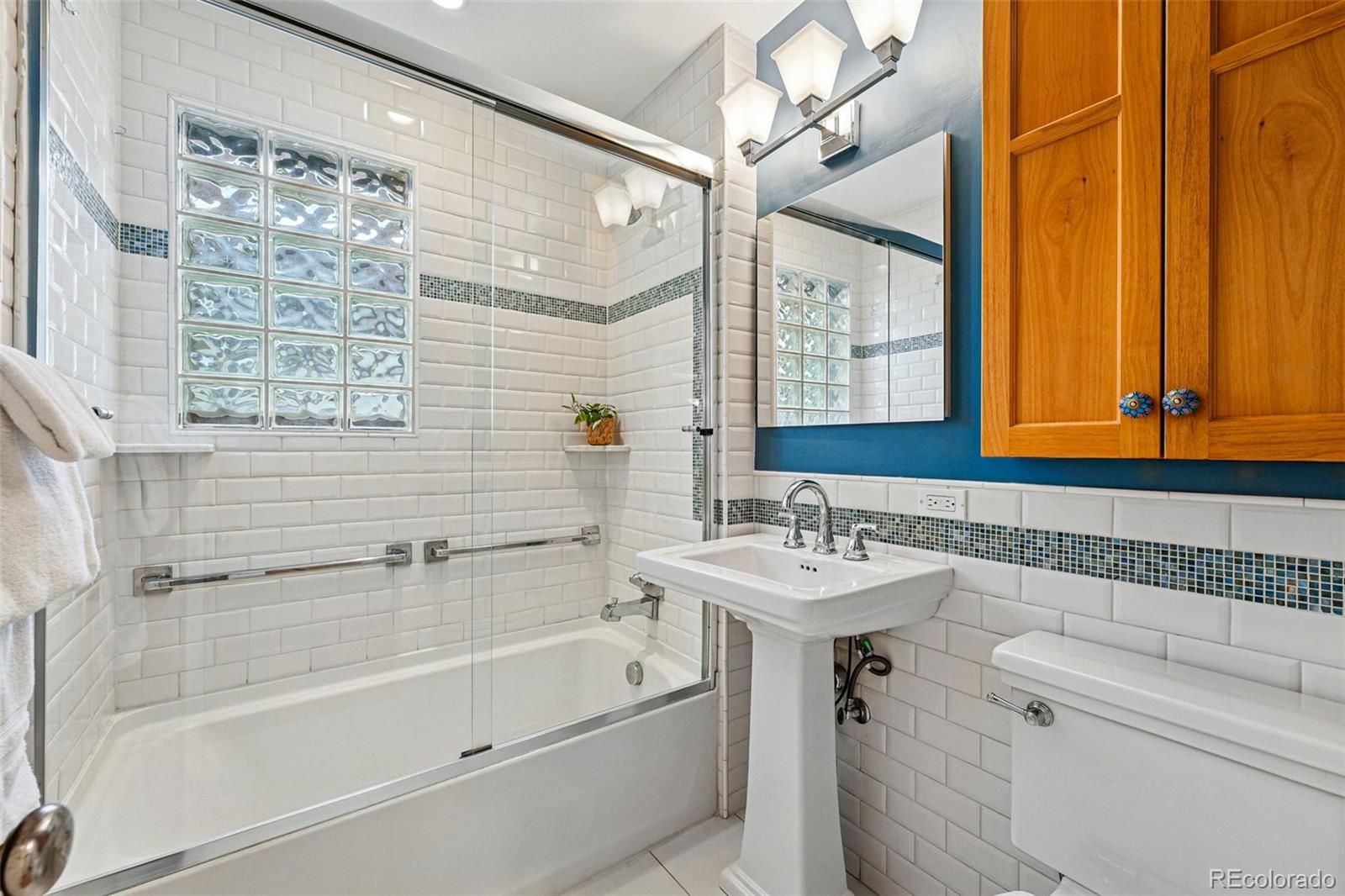 1312 Ash Street Denver, CO 80220 - Photo 25 of 31 a bathroom with a sink vanity mirror and a bathtub