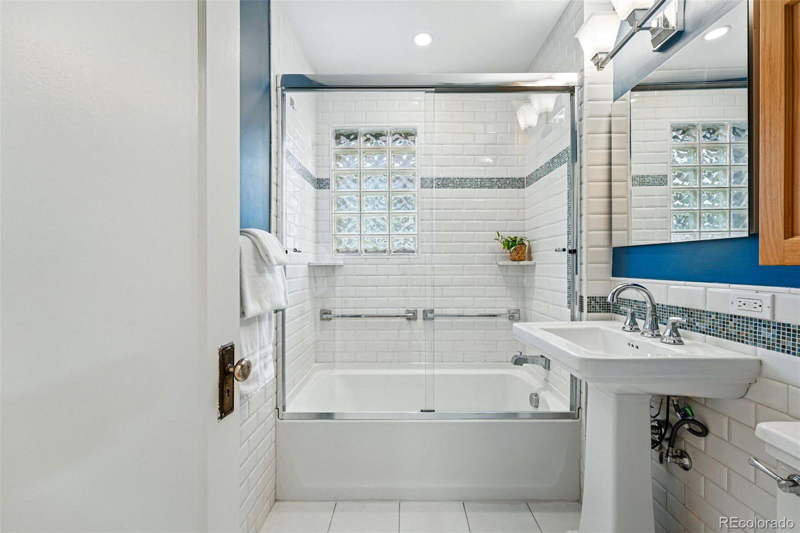 1312 Ash Street Denver, CO 80220 - Photo 26 of 31 a bathroom with a bathtub and a shower