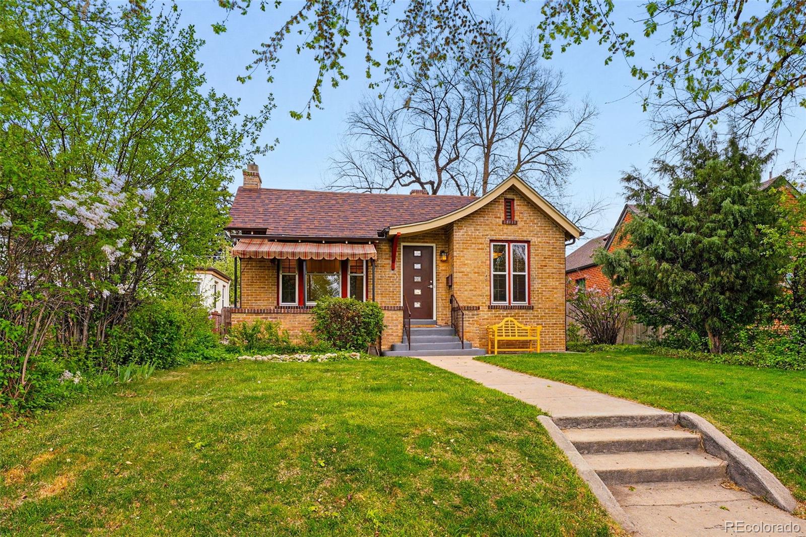 1312 Ash Street Denver, CO 80220 - Photo 3 of 31 a front view of a house with garden
