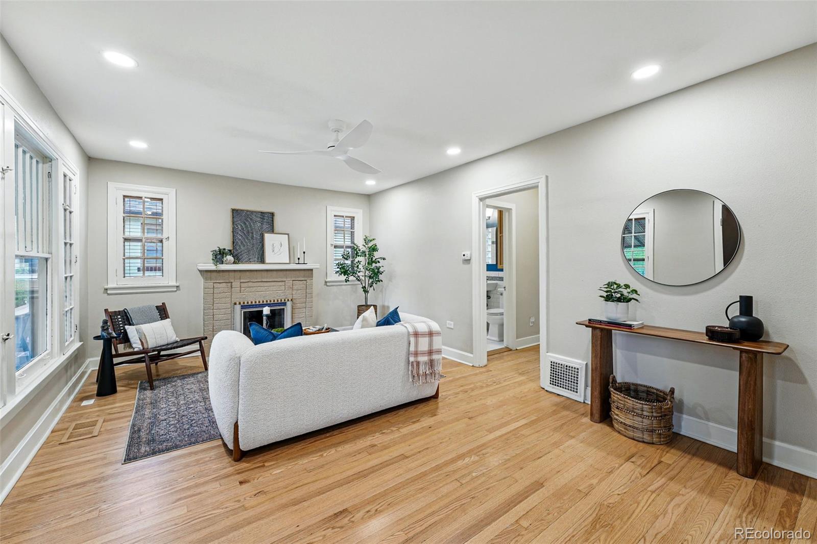 1312 Ash Street Denver, CO 80220 - Photo 6 of 31 a living room with fireplace furniture and a wooden floor