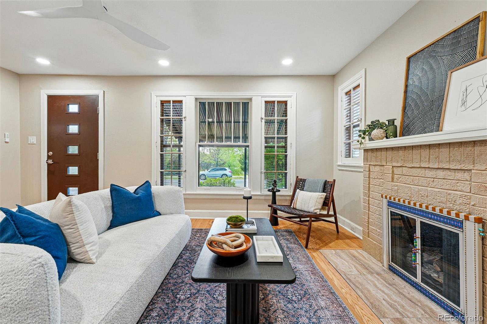 1312 Ash Street Denver, CO 80220 - Photo 9 of 31 a living room with furniture and a fireplace