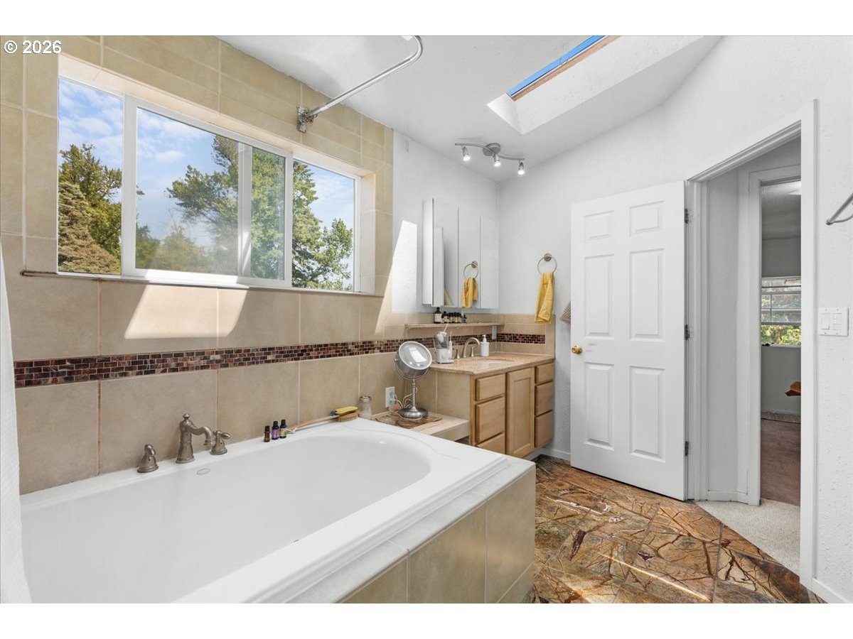 772 Division Street Oregon City, OR 97045 - Photo 17 of 47 a bathroom with a sink and a painting on the wall