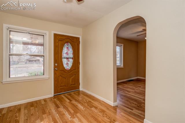 611 Prairie Road Colorado Springs, CO 80909 - Photo 4 of 18 Wood laminate flooring invites you inside and plenty of natural light keeps the home bright throughout the day.