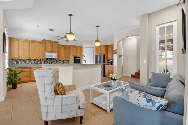 a bathroom with a granite countertop sink mirror vanity and toilet