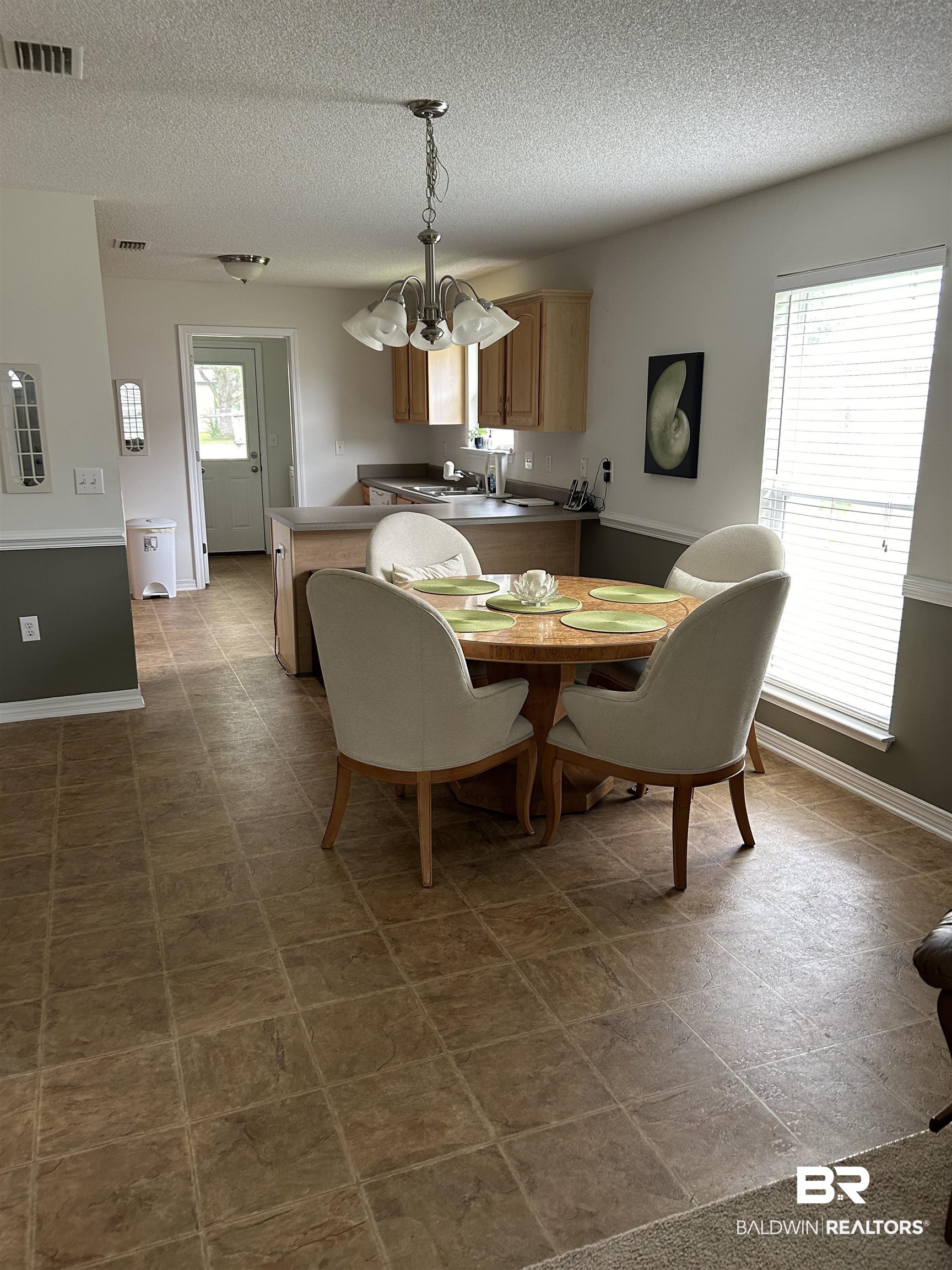 16976 Sugar Loop Foley, AL 36535 - Photo 5 of 16 Dining area featuring a textured ceiling and a chandelier