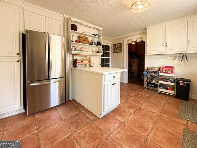 a kitchen with stainless steel appliances granite countertop a refrigerator and a stove top oven