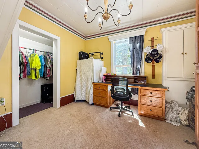a bedroom with furniture and a window