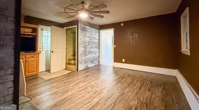 wooden floor in an empty room with a window