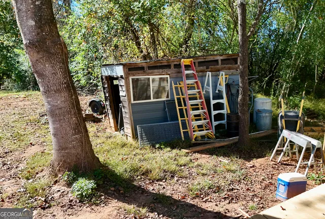 a view of a wooden house with a yard