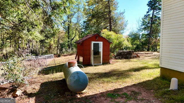 a backyard of a house with yard and trampoline