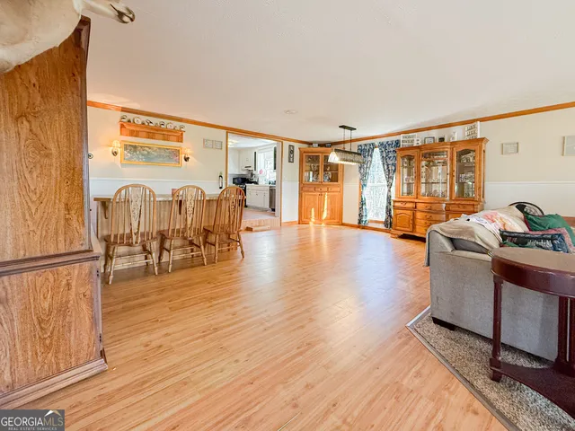 a living room with furniture and a table with wooden floor