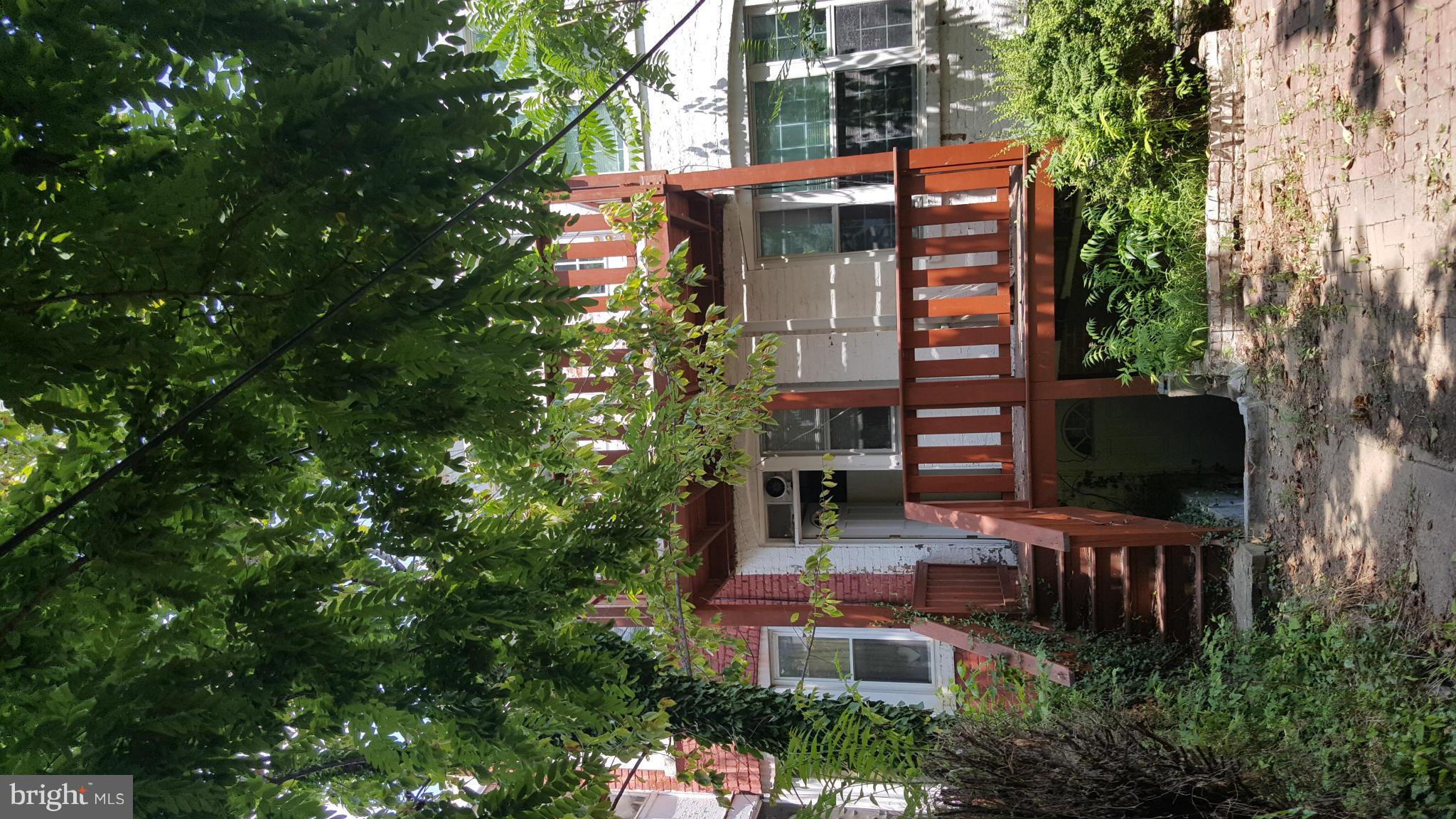 1410 Perry Place Northwest Washington, DC 20010 - Photo 2 of 11 a backyard of a building with trees
