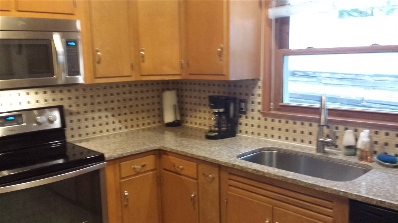 5118 Highcrest Road Rockford, IL 61107 - Photo 3 of 19 a kitchen with granite countertop a sink and a stove