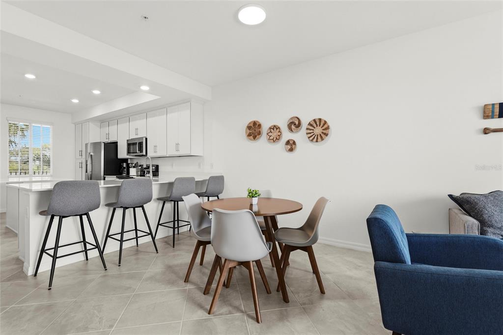 43985 Boardwalk Loop, Unit 2124 Punta Gorda, FL 33982 - Photo 17 of 80 a view of kitchen with stainless steel appliances granite countertop a dining table and chairs in it