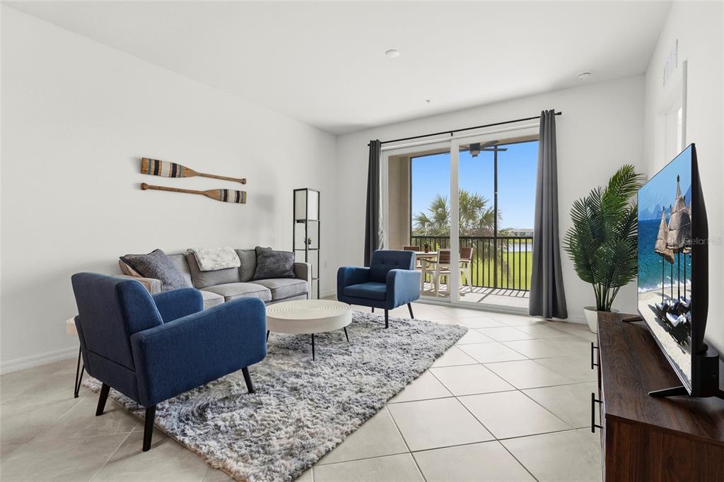 43985 Boardwalk Loop, Unit 2124 Punta Gorda, FL 33982 - Photo 19 of 80 a living room with furniture large window and a flat screen tv