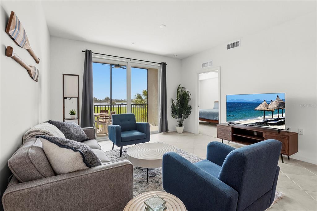 43985 Boardwalk Loop, Unit 2124 Punta Gorda, FL 33982 - Photo 6 of 80 a living room with furniture or couch and a fireplace