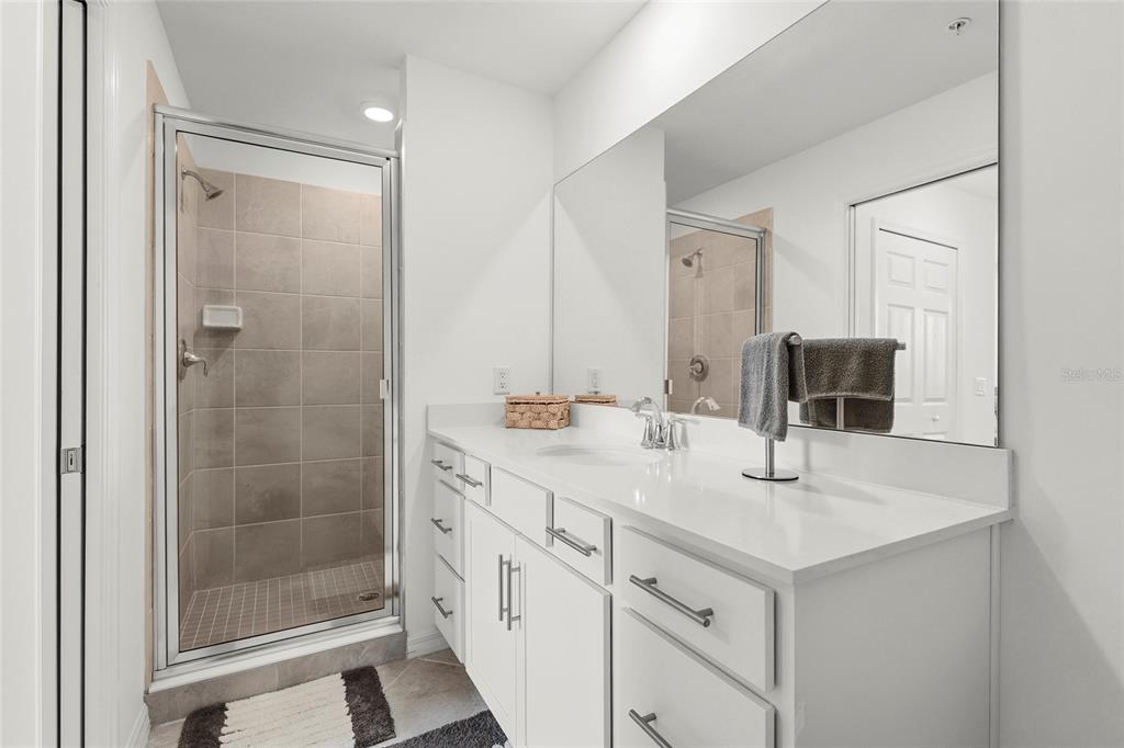 43985 Boardwalk Loop, Unit 2124 Punta Gorda, FL 33982 - Photo 8 of 80 a bathroom with a shower sink and mirror