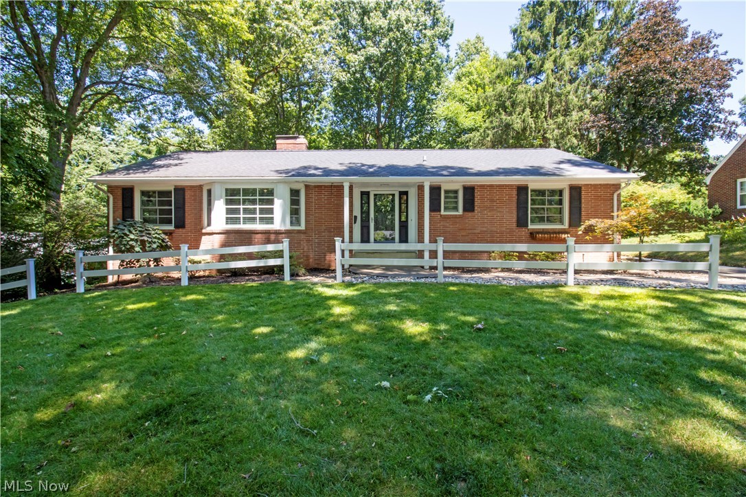 Single story home with a front lawn