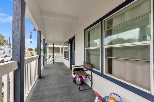 a view of gym equipment with wooden floor