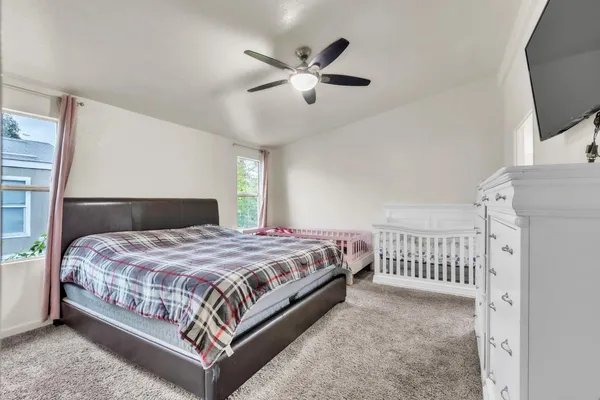 a bedroom with a bed and window