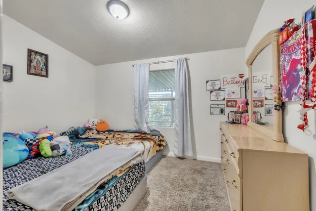 a bedroom with a bed and a dresser