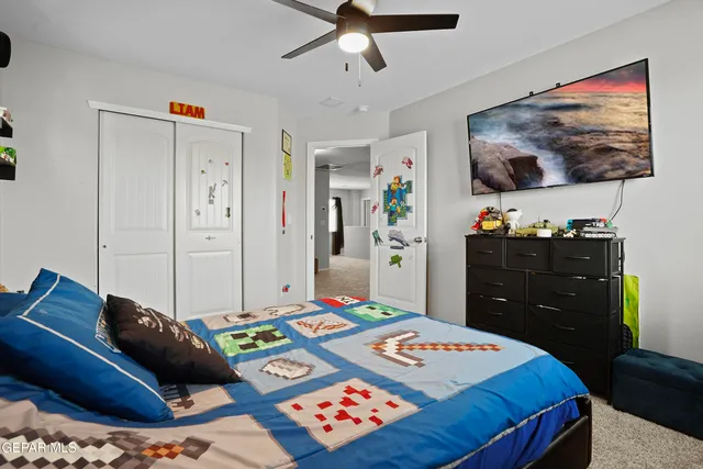 a bedroom with a bed and a chandelier