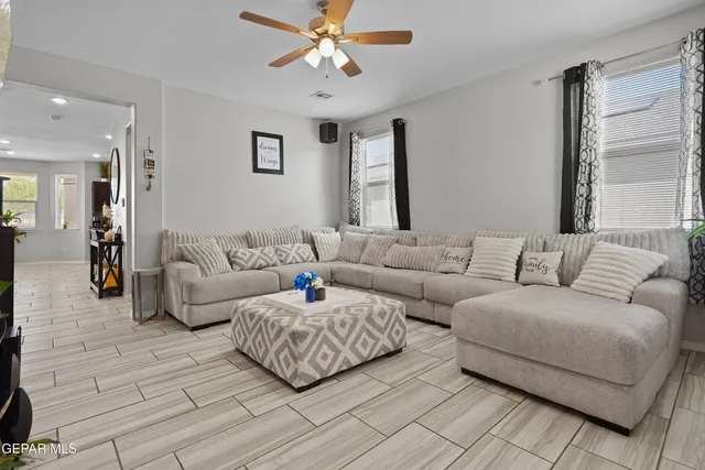 a living room with furniture and a chandelier