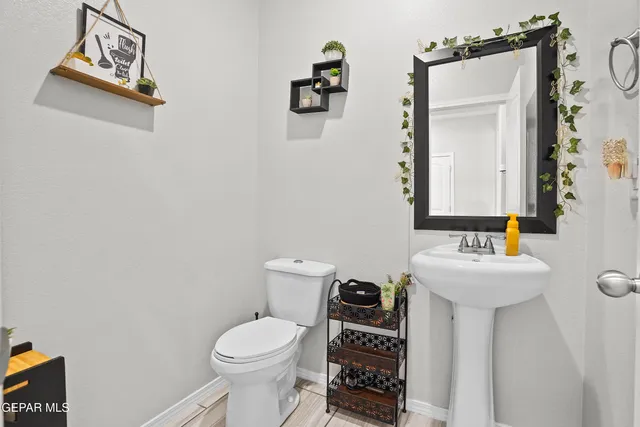 a bathroom with a sink toilet and mirror