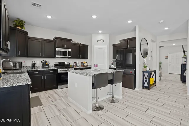 a kitchen with a sink cabinets and stainless steel appliances
