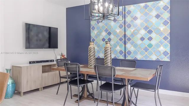 a view of a dining room with furniture and chandelier
