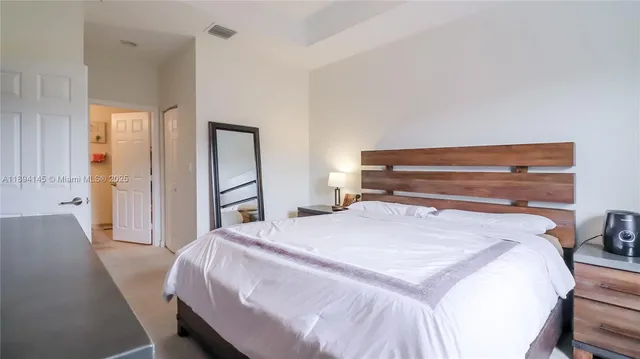 a bedroom with a bed and a dresser