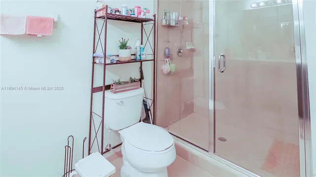 a white toilet sitting next to a bathroom sink