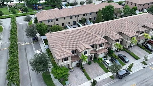 an aerial view of a house with garden space and street view