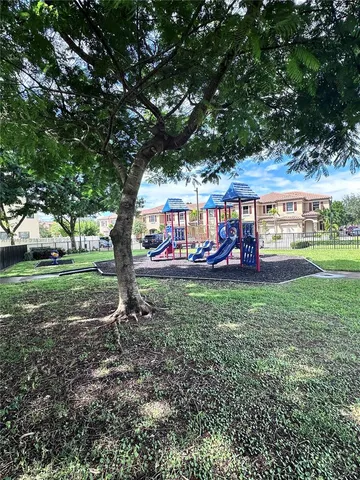 a view of a park with large trees