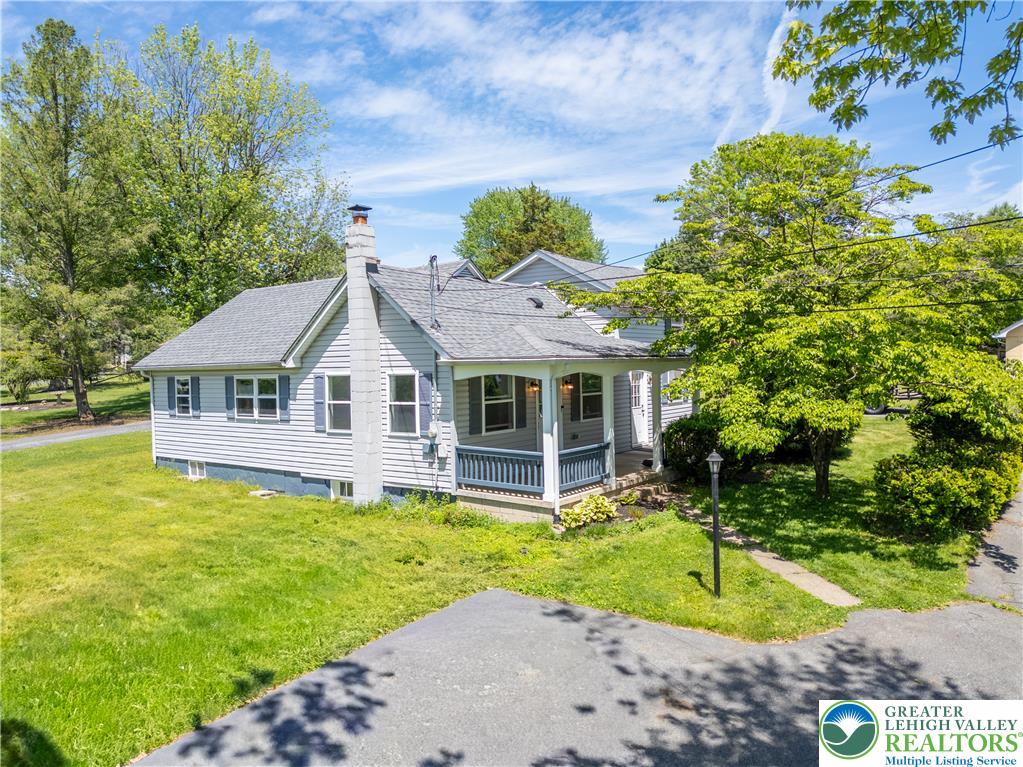 1411 Lieb Road Easton, PA 18040 - Photo 4 of 46 A welcoming front porch enhances this charming residence, framed by mature trees and a neatly kept lawn.