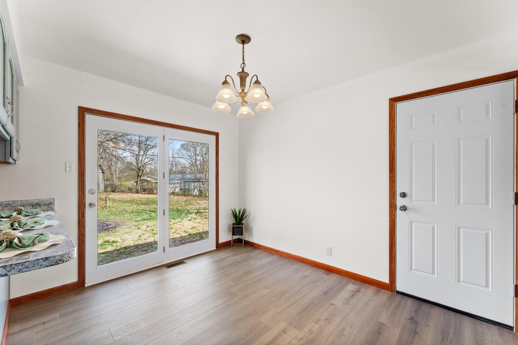 10473 North 493 East Demotte, IN 46310 - Photo 12 of 35 a view of a livingroom with wooden floor and a large window