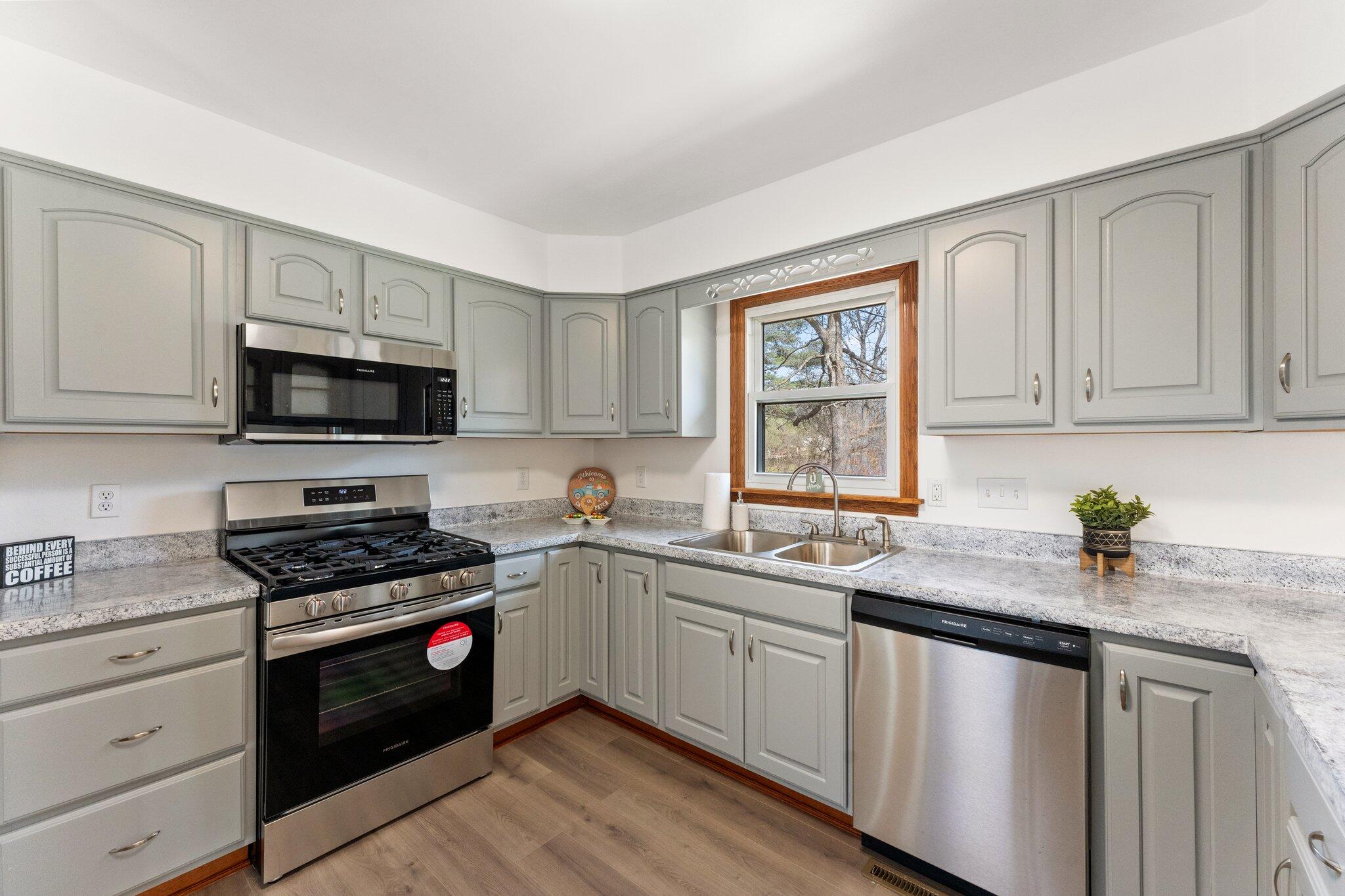 10473 North 493 East Demotte, IN 46310 - Photo 14 of 35 a kitchen with sink a microwave and cabinets