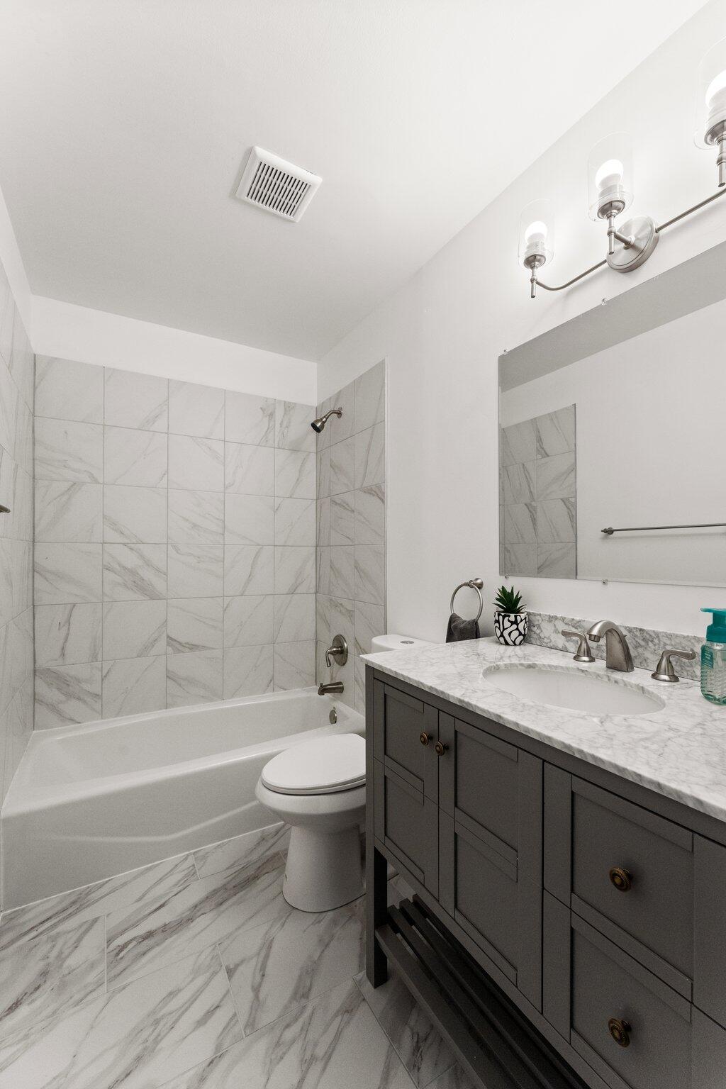 10473 North 493 East Demotte, IN 46310 - Photo 19 of 35 a bathroom with a double vanity sink toilet mirror and bathtub
