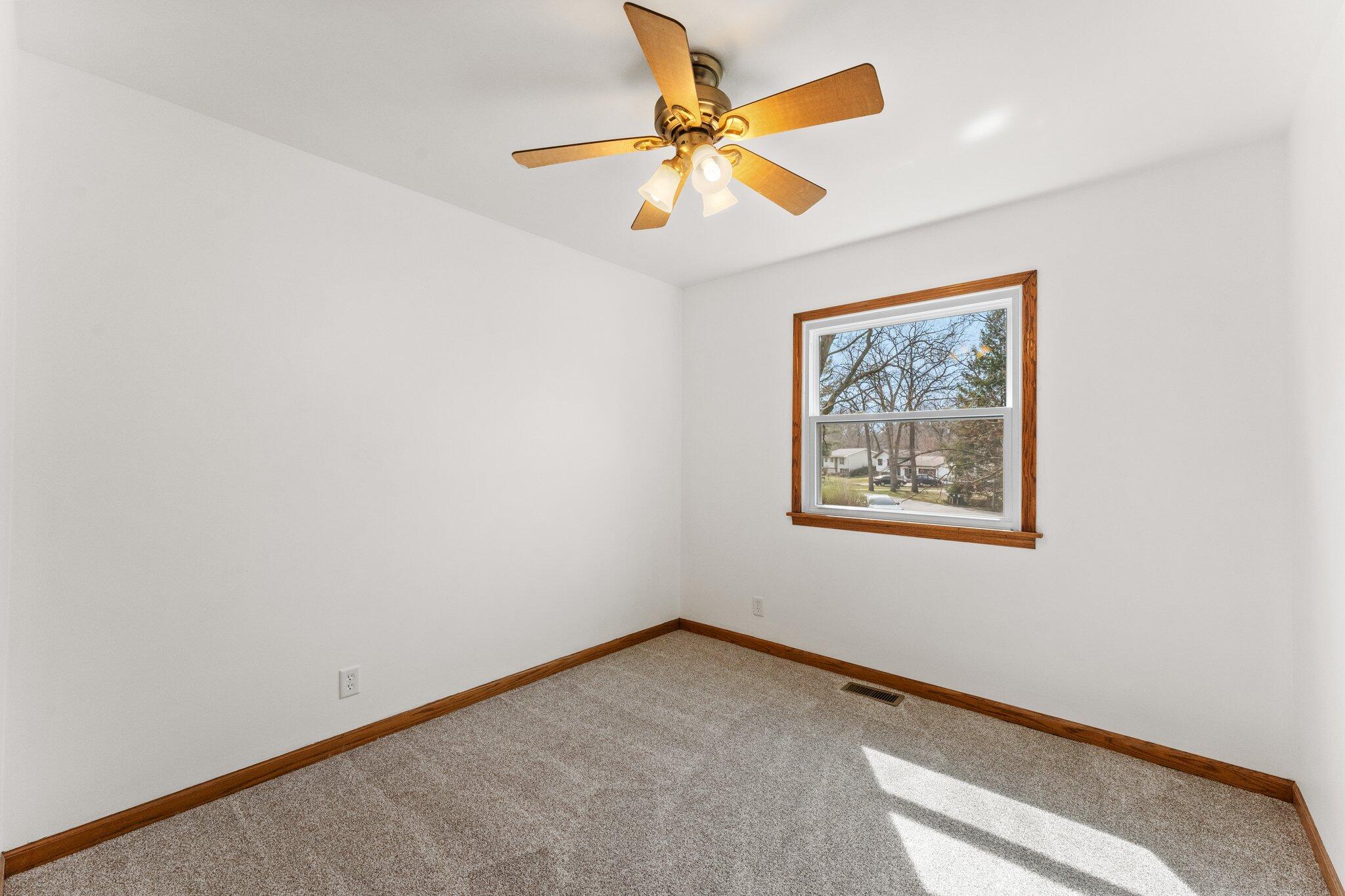 10473 North 493 East Demotte, IN 46310 - Photo 21 of 35 an empty room with a window and a ceiling fan