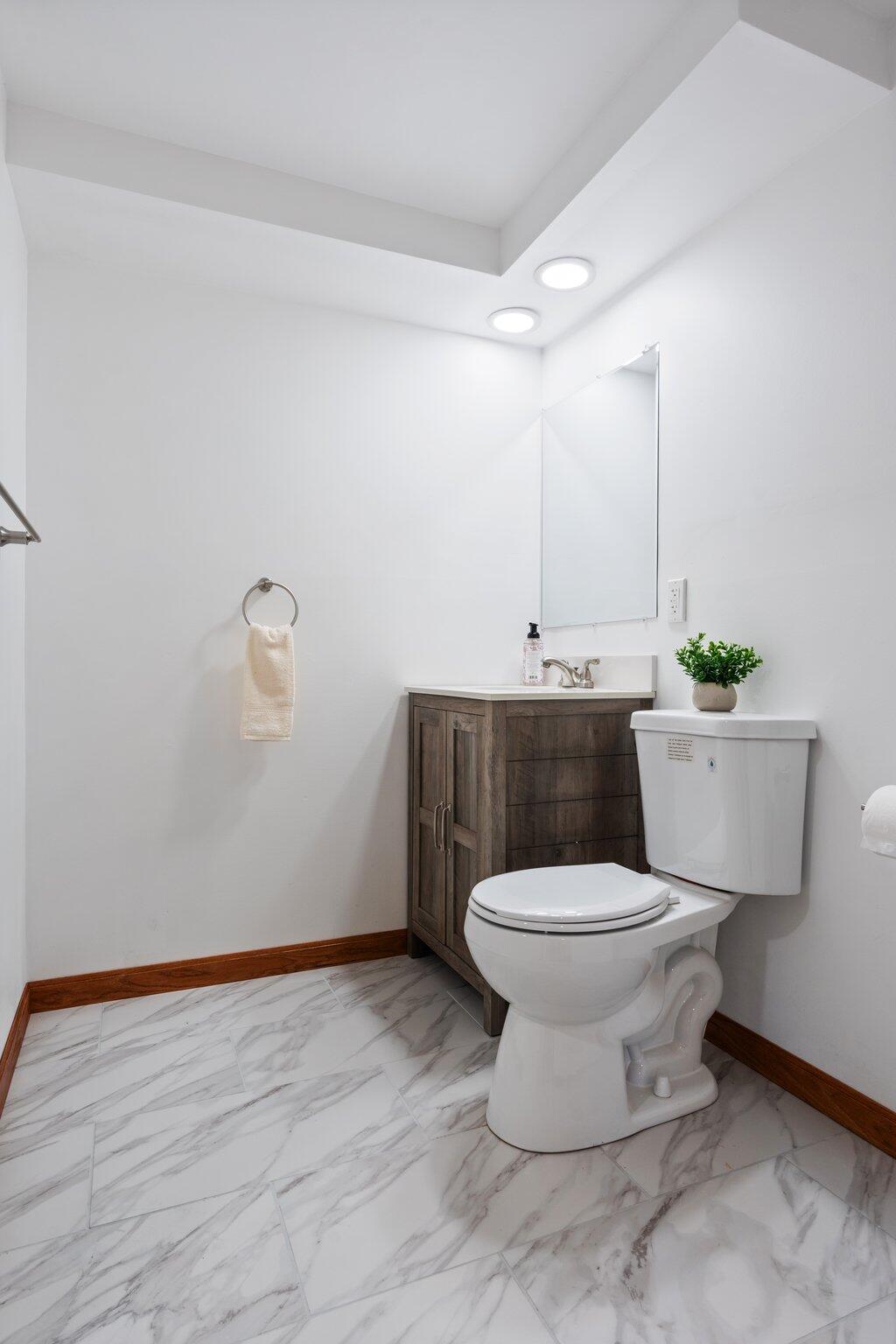 10473 North 493 East Demotte, IN 46310 - Photo 24 of 35 a bathroom with a toilet sink and mirror