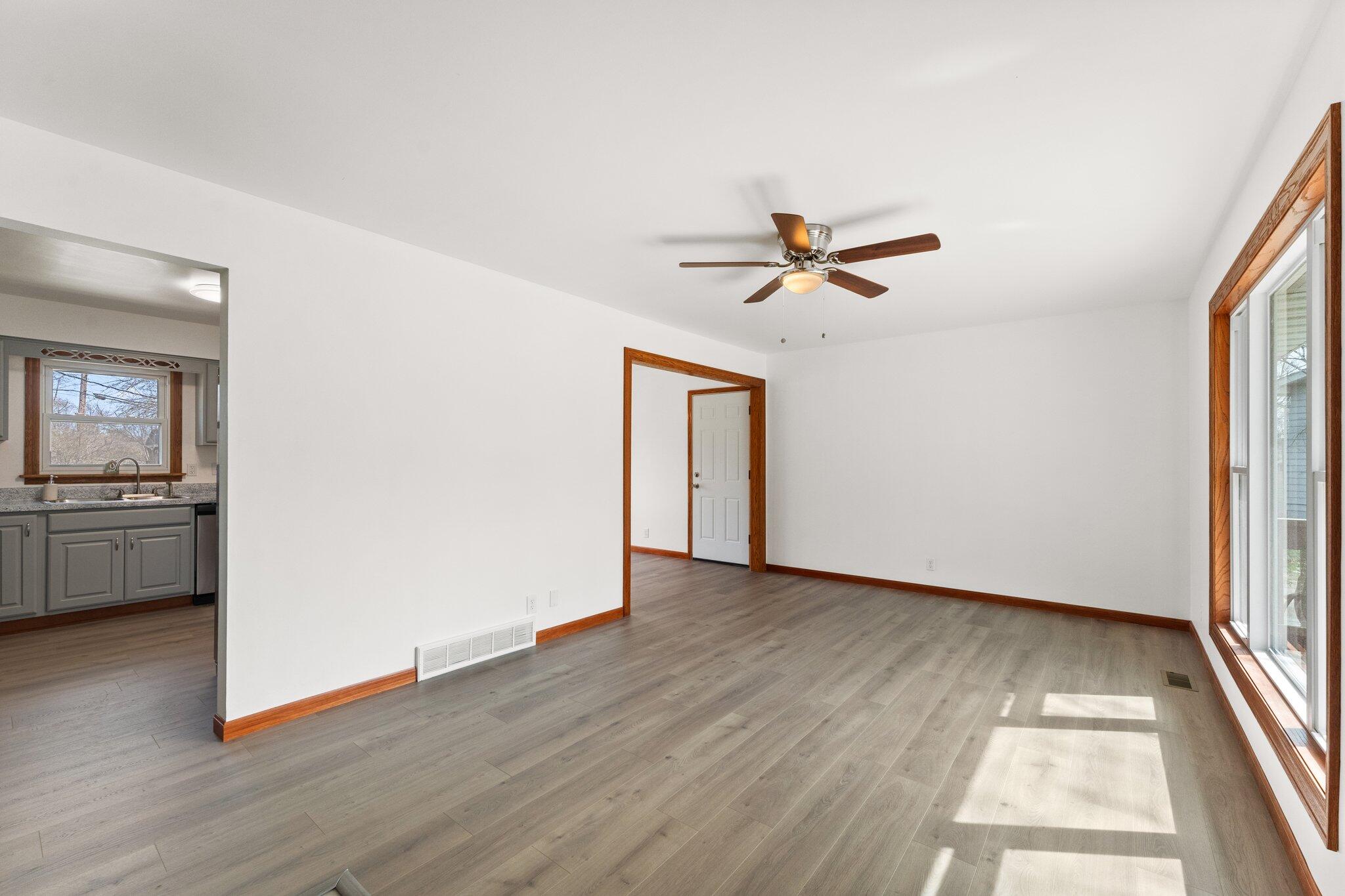 10473 North 493 East Demotte, IN 46310 - Photo 5 of 35 an empty room with wooden floor and a ceiling fan