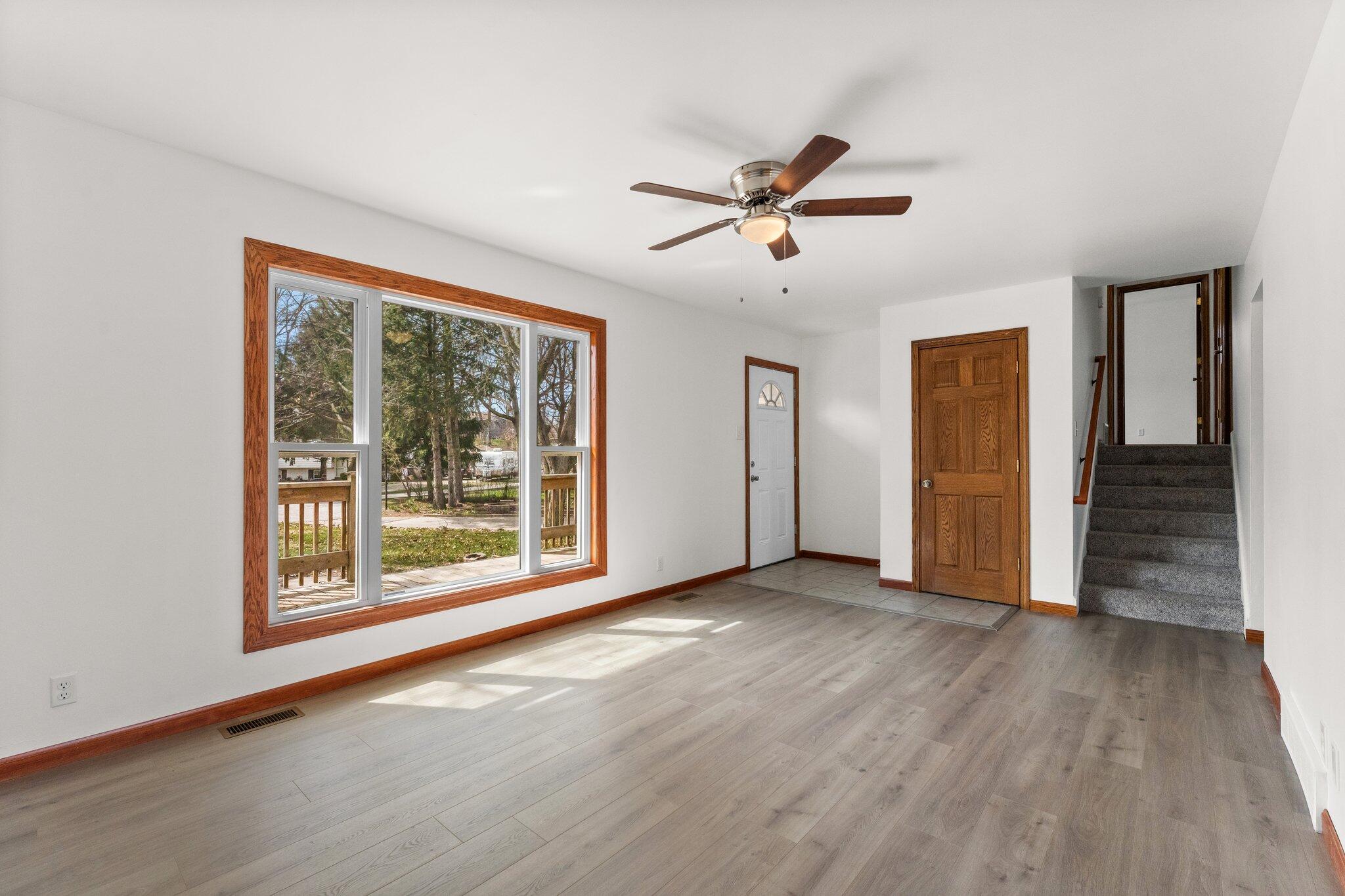 10473 North 493 East Demotte, IN 46310 - Photo 9 of 35 a view of an empty room with wooden floor and a window